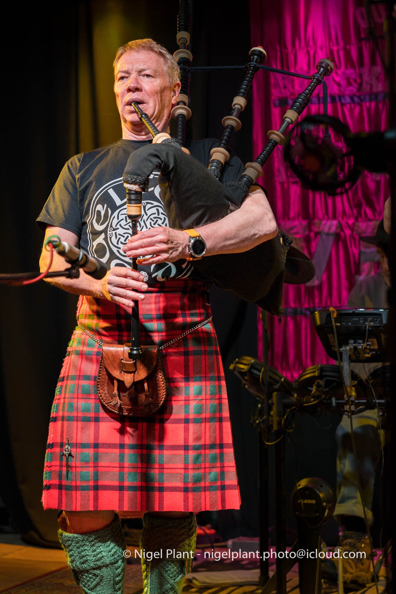 Craig McIntosh performing on stage with the bagpipes