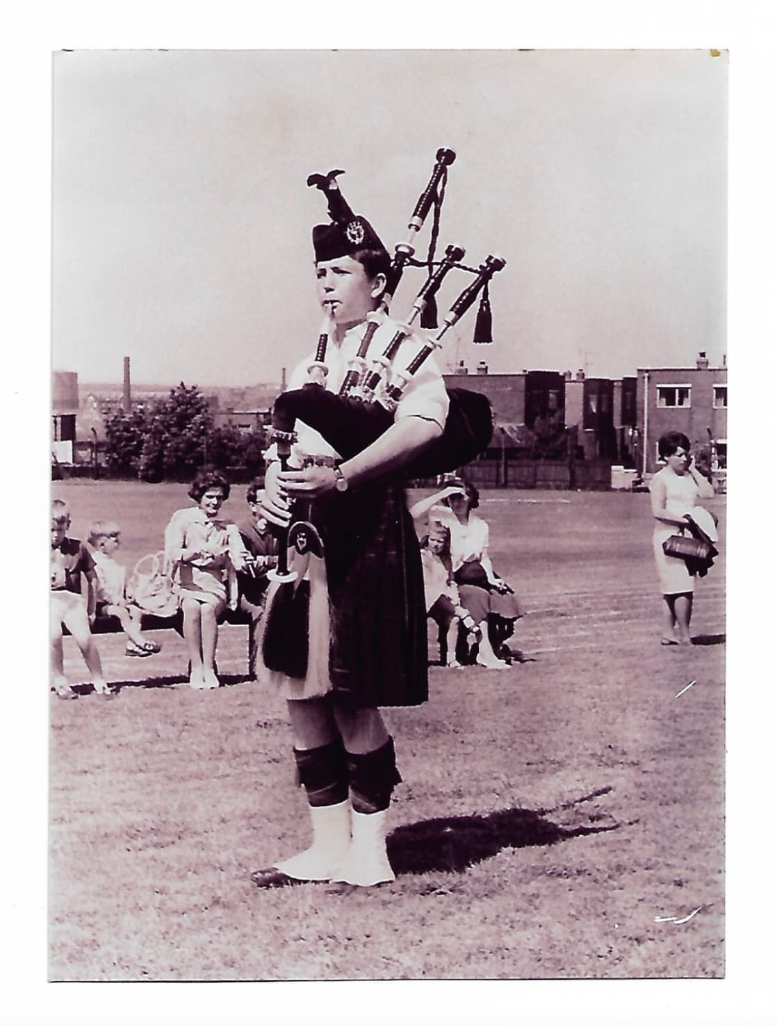 Young John Walsh playing bagpipes for highland dancers, around age 13